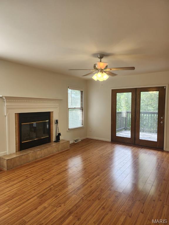 108 Auburn Dr, Waynesville, MO 65583 - unfurnished living room featuring wood finished floors, ceiling fan, a fireplace, and baseboards