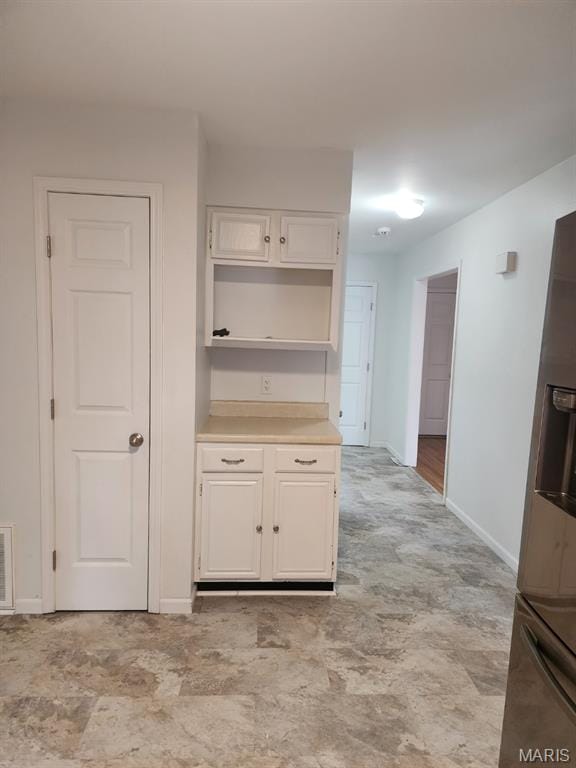 108 Auburn Dr, Waynesville, MO 65583 - kitchen featuring fridge with ice dispenser, white cabinets, baseboards, and light countertops