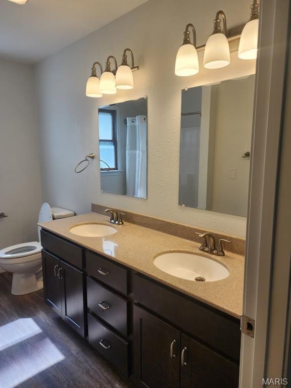 108 Auburn Dr, Waynesville, MO 65583 - full bath featuring wood finished floors, double vanity, and toilet