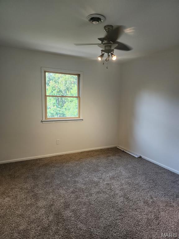 108 Auburn Dr, Waynesville, MO 65583 - spare room featuring ceiling fan, baseboards, and carpet