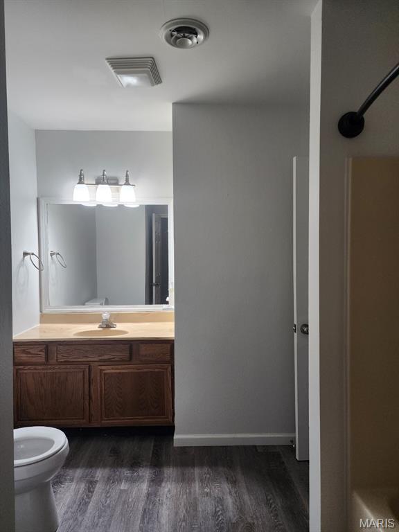 108 Auburn Dr, Waynesville, MO 65583 - full bath featuring wood finished floors, vanity, and toilet
