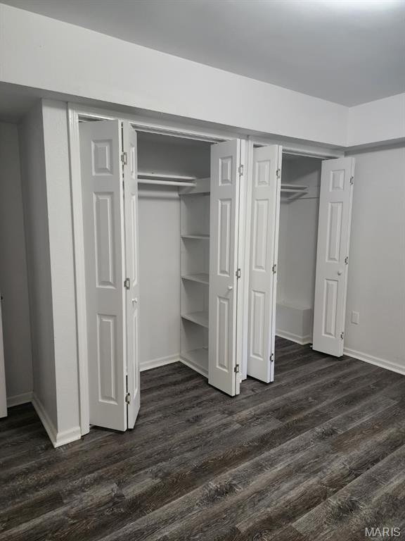 108 Auburn Dr, Waynesville, MO 65583 - unfurnished bedroom featuring dark wood-style flooring and baseboards