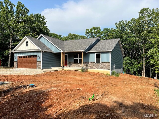 518 Rue Lamande, Bonne Terre, MO 63628 - craftsman house with stone siding, a garage, a porch, driveway, and roof with shingles