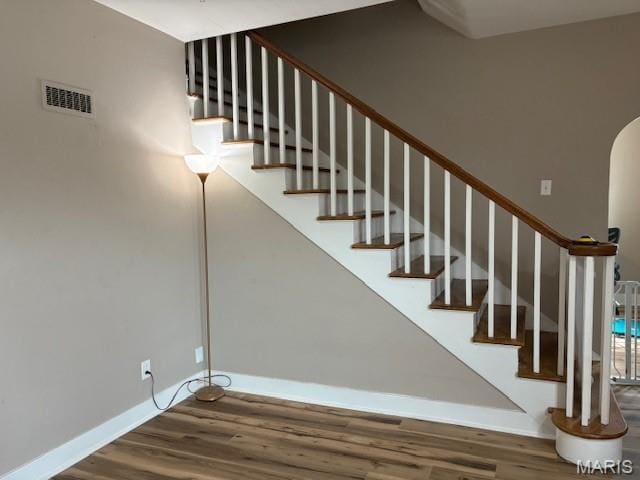10303 Lincoln Trl, Fairview Heights, IL 62208 - stairway featuring wood finished floors and arched walkways