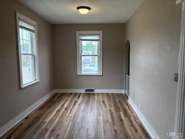 10303 Lincoln Trl, Fairview Heights, IL 62208 - empty room with wood finished floors and arched walkways