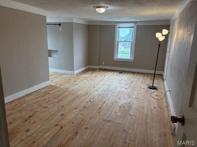 10303 Lincoln Trl, Fairview Heights, IL 62208 - empty room with wood-type flooring, ornamental molding, and a textured ceiling