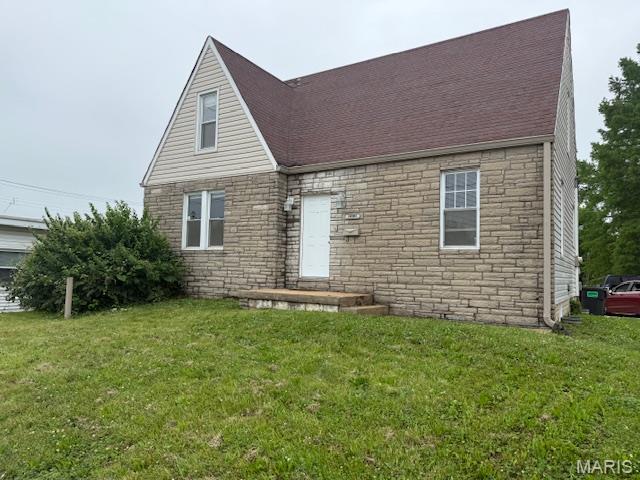 10303 Lincoln Trl, Fairview Heights, IL 62208 - view of front of house with stone siding, a front yard, and a shingled roof
