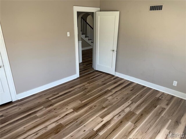 10303 Lincoln Trl, Fairview Heights, IL 62208 - unfurnished room with wood finished floors, stairs, and arched walkways