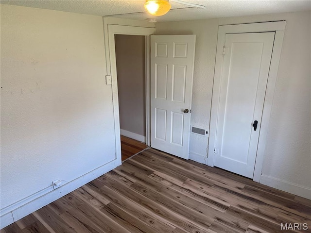10303 Lincoln Trl, Fairview Heights, IL 62208 - unfurnished bedroom with wood finished floors and a closet