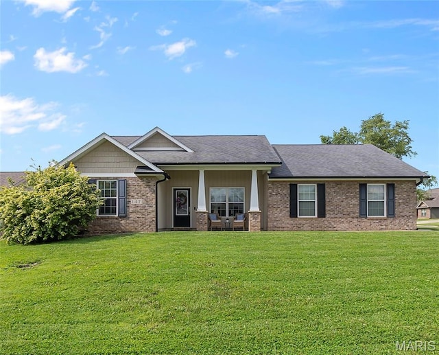 147 Old Towne Ln, Cape Girardeau, MO 63701 - view of front facade with a front lawn, brick siding, a porch, and a shingled roof