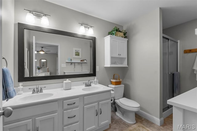 147 Old Towne Ln, Cape Girardeau, MO 63701 - bathroom with a shower stall, double vanity, ceiling fan, and toilet