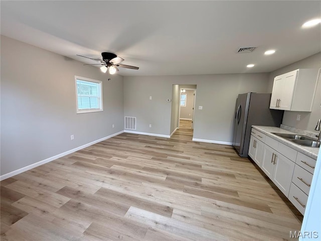 604 N Henderson St Unit A & B, Salem, MO 65560 - kitchen featuring a sink, ceiling fan, white cabinets, baseboards, and light countertops