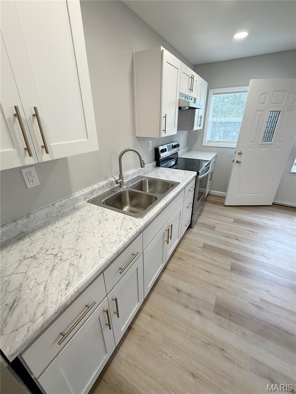 604 N Henderson St Unit A & B, Salem, MO 65560 - kitchen featuring electric stove, a sink, under cabinet range hood, white cabinetry, and light wood-type flooring