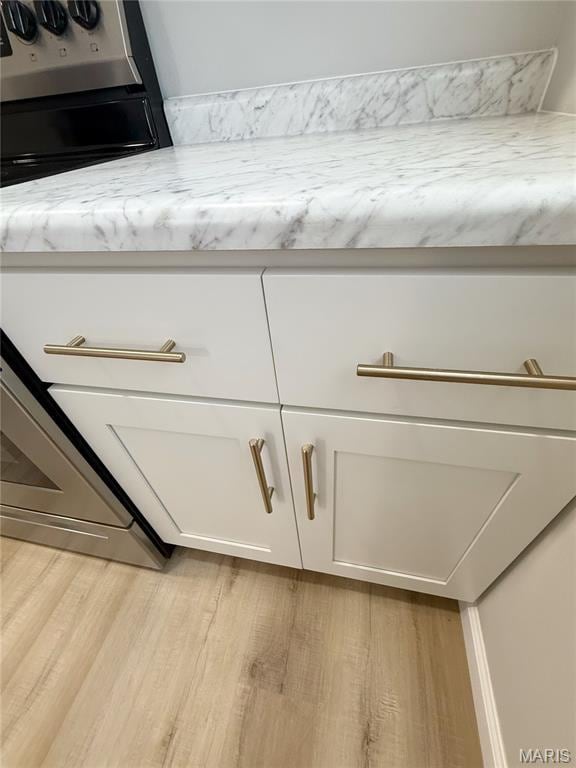 604 N Henderson St Unit A & B, Salem, MO 65560 - kitchen view of light wood-style flooring and white cabinetry