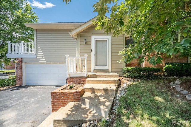 2237 Ole Castle Ct, Chesterfield, MO 63017 - property entrance with asphalt driveway, an attached garage, and brick siding