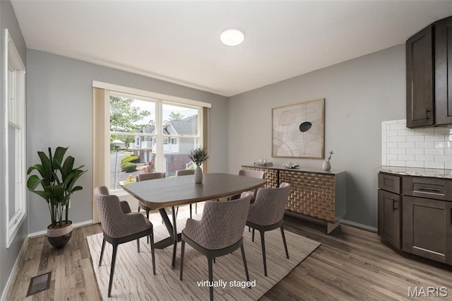 2237 Ole Castle Ct, Chesterfield, MO 63017 - dining space featuring light wood-style flooring and baseboards