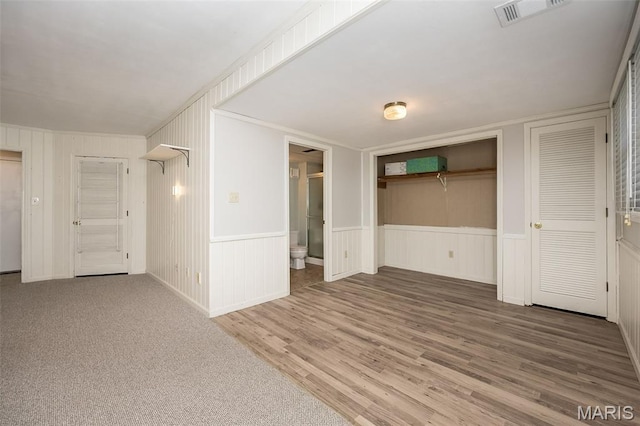 2237 Ole Castle Ct, Chesterfield, MO 63017 - unfurnished living room featuring wood finished floors, a wainscoted wall, and a decorative wall