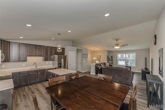 424 Triathlon Dr, Foristell, MO 63348 - dining room featuring lofted ceiling, wood finished floors, ceiling fan, recessed lighting, and baseboards