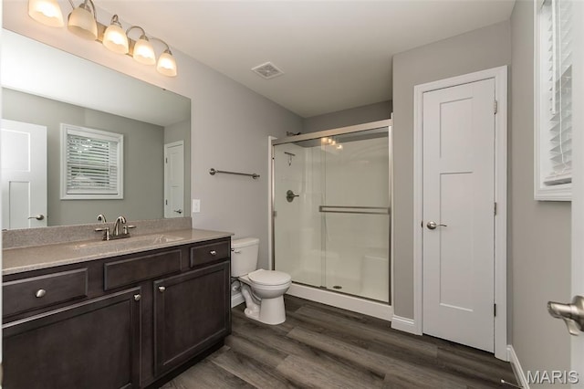 424 Triathlon Dr, Foristell, MO 63348 - full bathroom featuring toilet, wood finished floors, vanity, and a stall shower