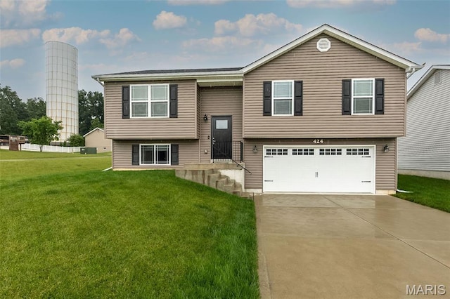 424 Triathlon Dr, Foristell, MO 63348 - split foyer home with an attached garage, a front yard, and concrete driveway