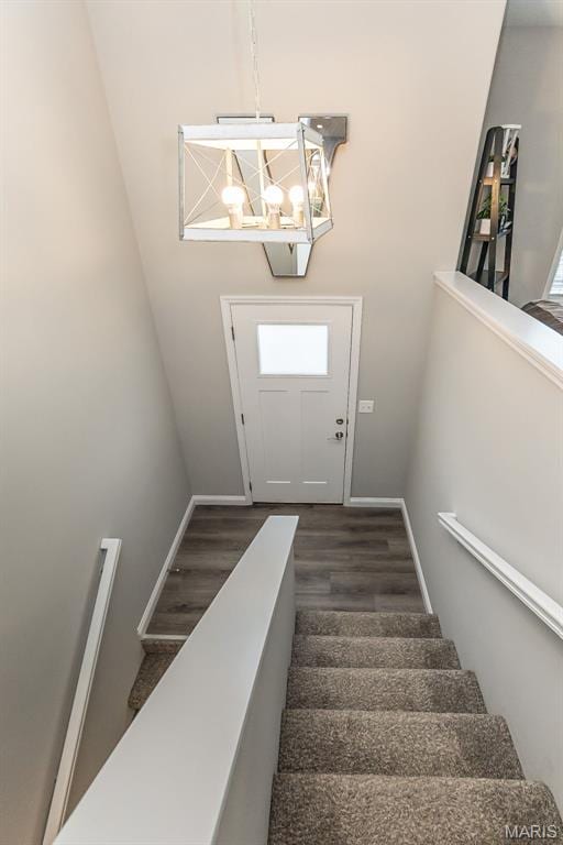 424 Triathlon Dr, Foristell, MO 63348 - staircase with wood finished floors, baseboards, and a chandelier