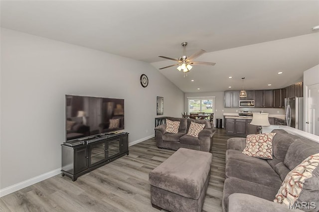 424 Triathlon Dr, Foristell, MO 63348 - living area with light wood-style floors, ceiling fan, vaulted ceiling, baseboards, and recessed lighting