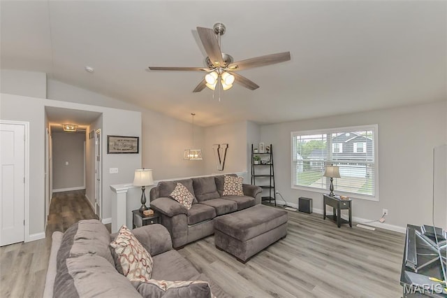 424 Triathlon Dr, Foristell, MO 63348 - living room featuring wood finished floors, vaulted ceiling, ceiling fan, and baseboards