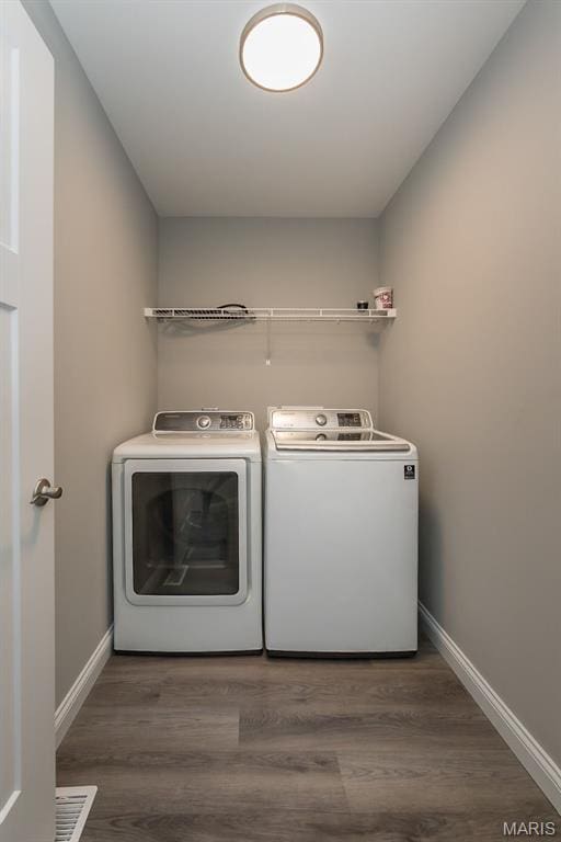 424 Triathlon Dr, Foristell, MO 63348 - laundry room with separate washer and dryer, baseboards, and wood finished floors