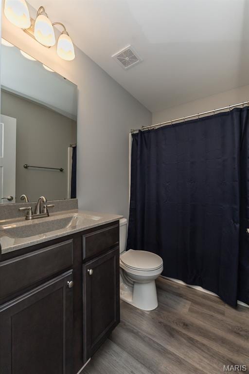 424 Triathlon Dr, Foristell, MO 63348 - full bathroom featuring wood finished floors, vanity, and toilet