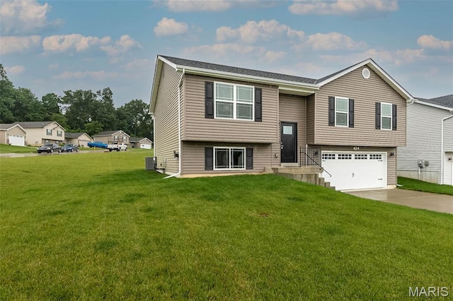 424 Triathlon Dr, Foristell, MO 63348 - bi-level home featuring central AC, concrete driveway, an attached garage, and a front yard