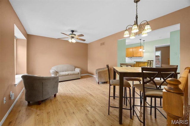 205 Fawn Meadow Ct, Ofallon, MO 63366 - dining space with light wood finished floors, a ceiling fan, and plenty of natural light