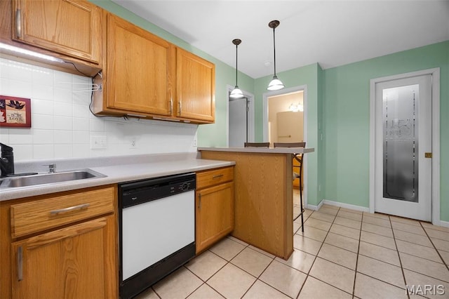 205 Fawn Meadow Ct, Ofallon, MO 63366 - kitchen with white dishwasher, backsplash, light tile patterned flooring, decorative light fixtures, and light countertops