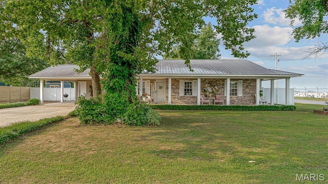 17504 Division St, Kennett, MO 63857 - view of front facade featuring metal roof, driveway, an attached carport, and a porch