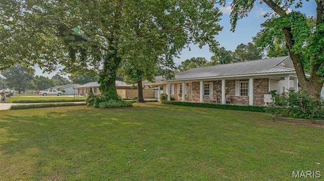 17504 Division St, Kennett, MO 63857 - ranch-style house featuring a front lawn, a porch, and stone siding