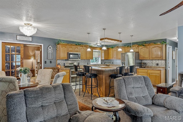 17504 Division St, Kennett, MO 63857 - living area with a textured ceiling and a chandelier