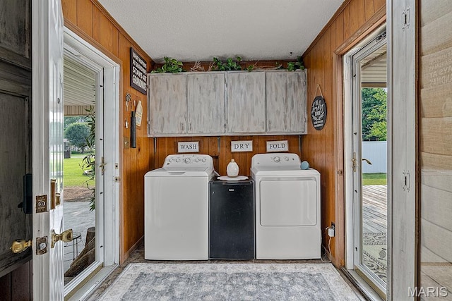 17504 Division St, Kennett, MO 63857 - laundry room with washer and dryer, cabinet space, wooden walls, and a textured ceiling
