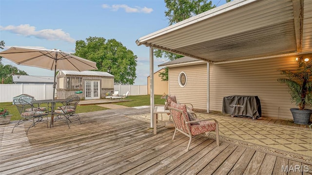 17504 Division St, Kennett, MO 63857 - wooden deck featuring french doors, an outbuilding, and outdoor dining space