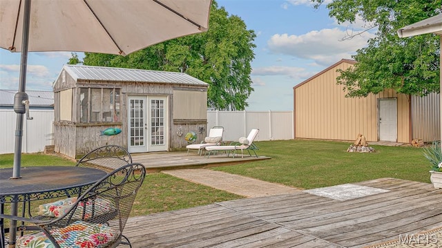 17504 Division St, Kennett, MO 63857 - wooden terrace featuring french doors and an outbuilding