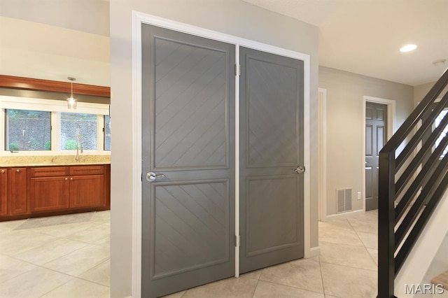 6620 Lake Point Dr Unit 26, Osage Beach, MO 65065 - hallway with light tile patterned floors, a sink, recessed lighting, and baseboards