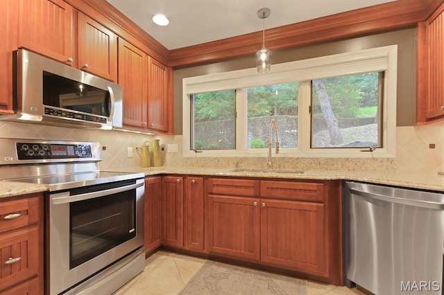 6620 Lake Point Dr Unit 26, Osage Beach, MO 65065 - kitchen with stainless steel appliances, a sink, brown cabinets, light stone countertops, and tasteful backsplash