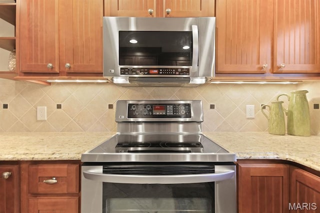 6620 Lake Point Dr Unit 26, Osage Beach, MO 65065 - kitchen with appliances with stainless steel finishes, tasteful backsplash, light stone counters, and open shelves