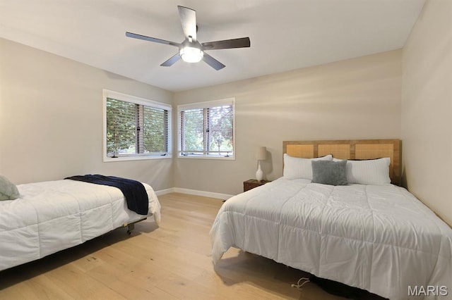 6620 Lake Point Dr Unit 26, Osage Beach, MO 65065 - bedroom featuring baseboards, light wood-type flooring, and a ceiling fan
