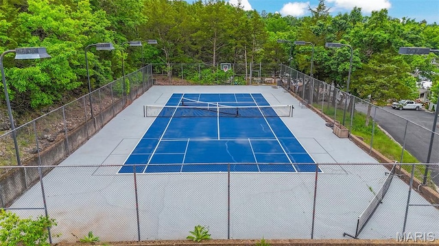 6620 Lake Point Dr Unit 26, Osage Beach, MO 65065 - view of tennis court featuring a wooded view