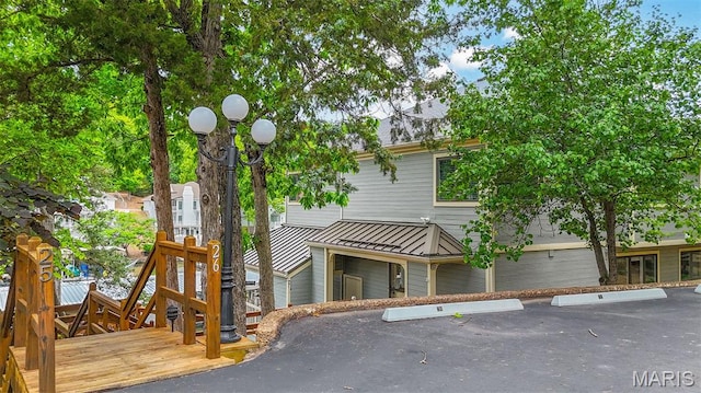 6620 Lake Point Dr Unit 26, Osage Beach, MO 65065 - view of property featuring a standing seam roof, uncovered parking, and a metal roof