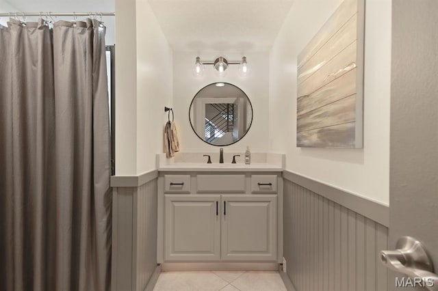 6620 Lake Point Dr Unit 26, Osage Beach, MO 65065 - full bath featuring wainscoting, vanity, tile patterned flooring, and a shower with curtain