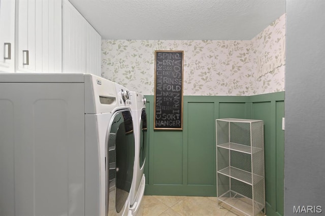 6620 Lake Point Dr Unit 26, Osage Beach, MO 65065 - washroom with wallpapered walls, independent washer and dryer, cabinet space, a wainscoted wall, and a decorative wall
