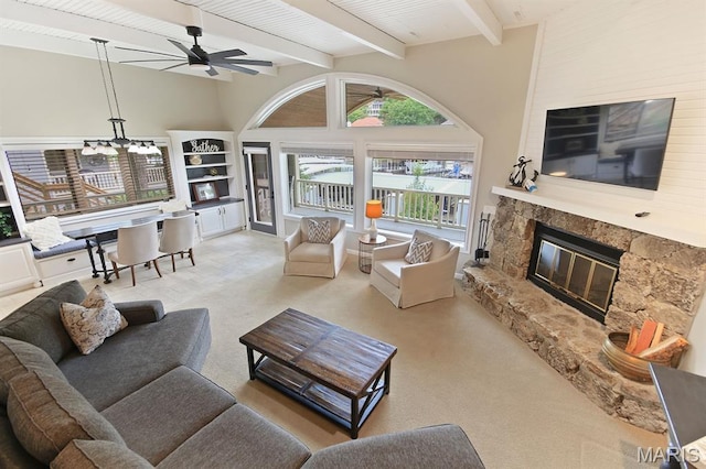 6620 Lake Point Dr Unit 26, Osage Beach, MO 65065 - living area with a high end fireplace, a ceiling fan, carpet, beamed ceiling, and a chandelier