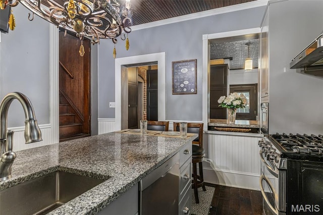 698N 3rd St, Saint Genevieve, MO 63670 - kitchen featuring stainless steel appliances, a chandelier, stone countertops, dark wood-type flooring, and a wainscoted wall
