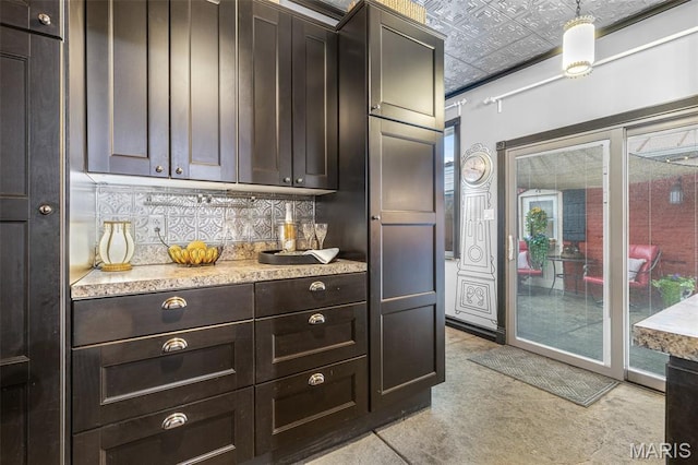 698N 3rd St, Saint Genevieve, MO 63670 - kitchen with an ornate ceiling, tasteful backsplash, dark brown cabinetry, and pendant lighting