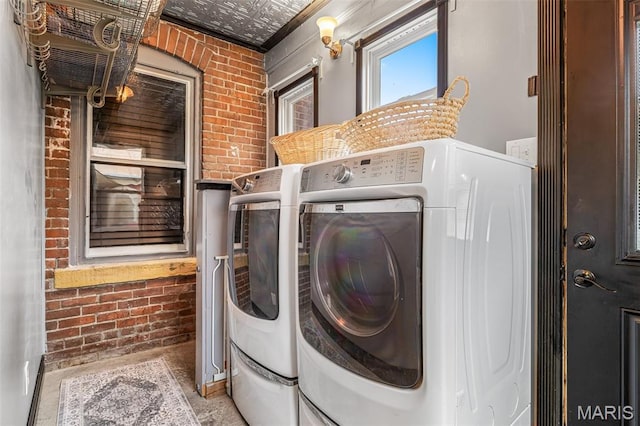 698N 3rd St, Saint Genevieve, MO 63670 - laundry area with brick wall, separate washer and dryer, and an ornate ceiling